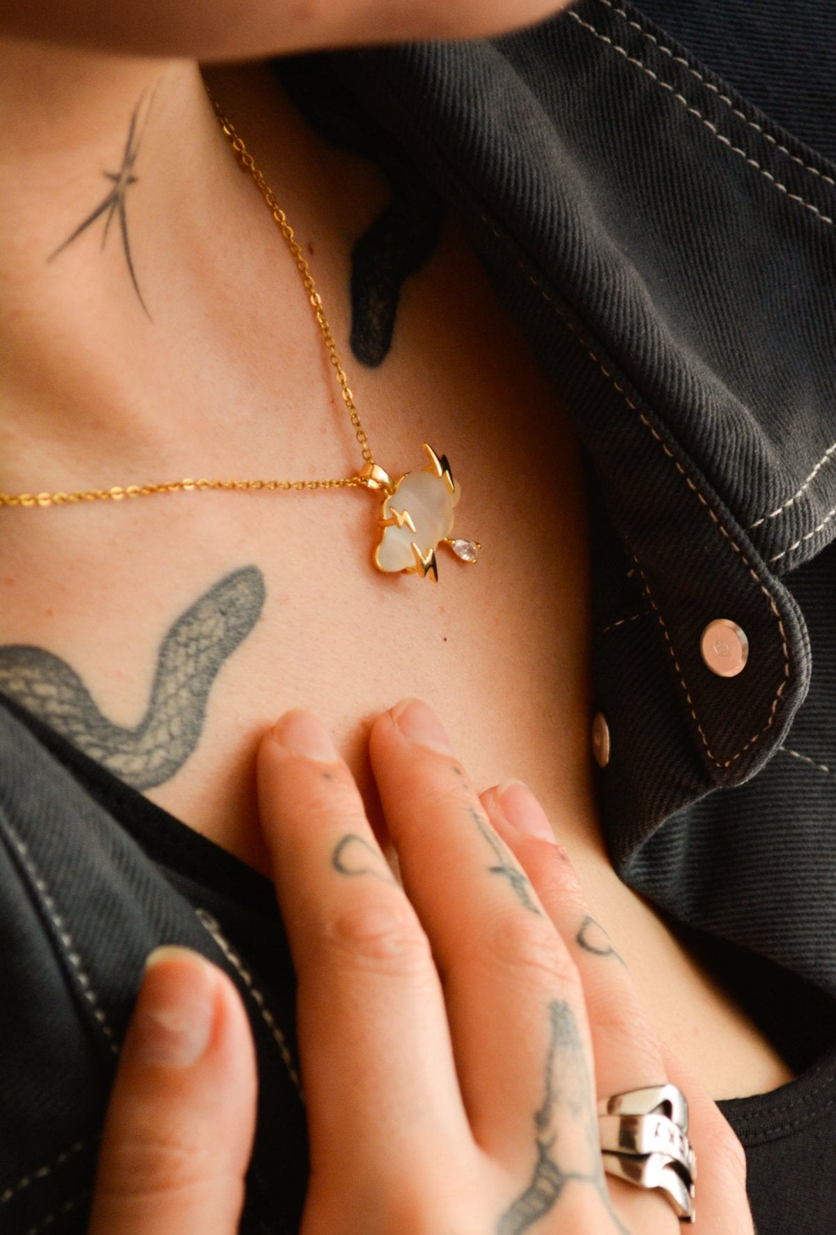 After The Storm gold necklace with a white resin cloud pendant, lightning bolts and crystal raindrop